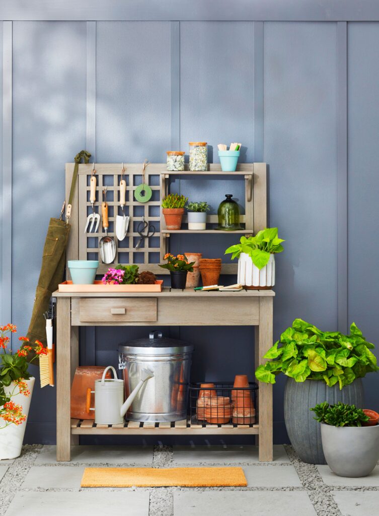 A wooden bench with hidden storage and soft cushions in a garden setting.