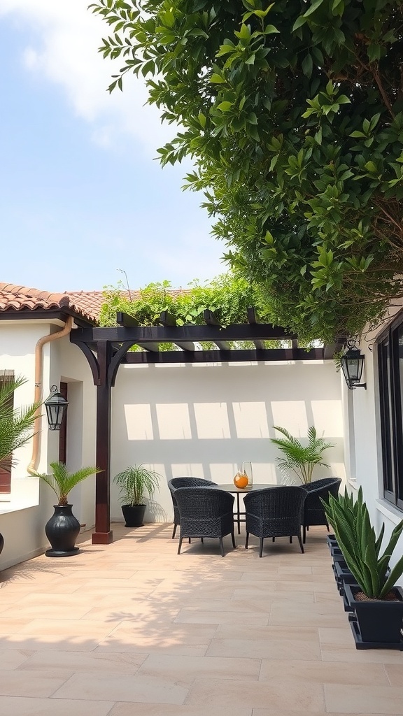 A small courtyard with a wooden pergola, two chairs, a table, and greenery.